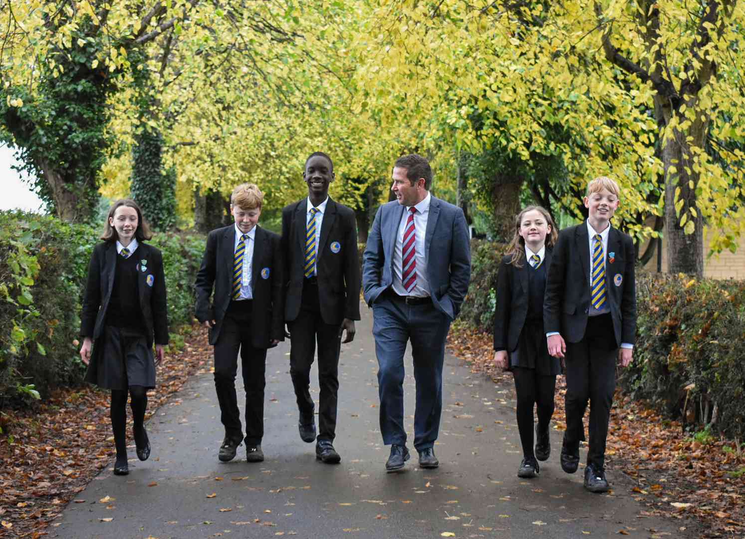 students and teacher walking
